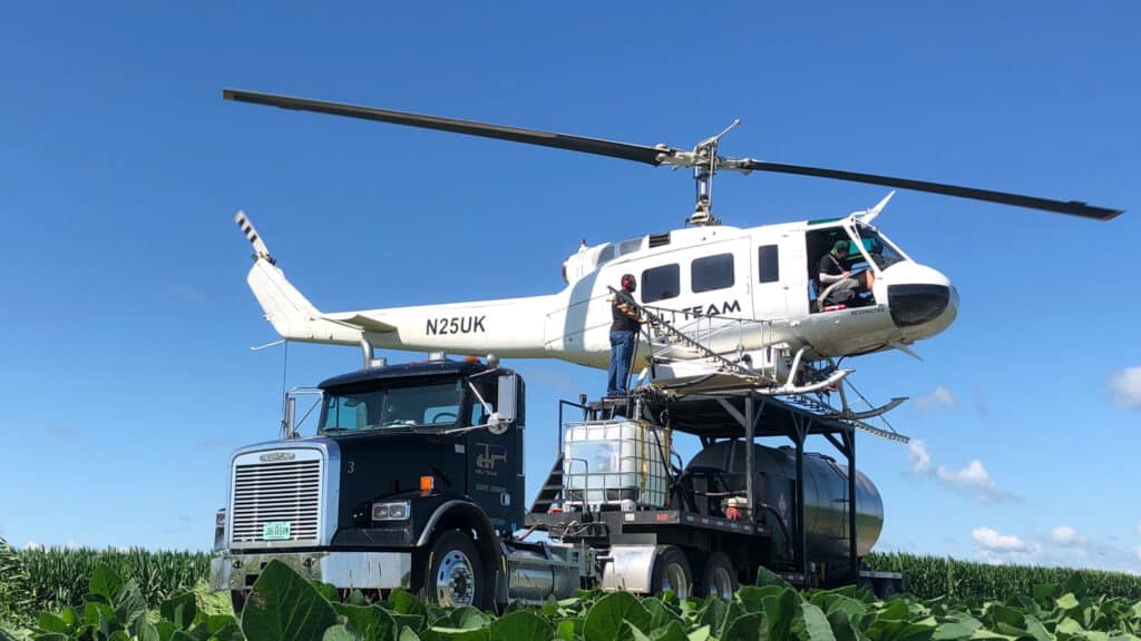 Bell UH-1H Huey Helicopter on truck crop dusting helicopter